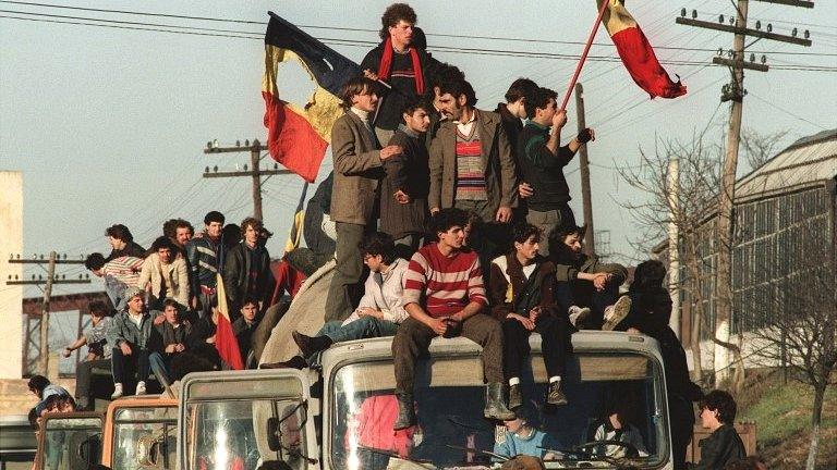 Romanians celebrate the downfall Nicolae Ceaucescu in the border town of Denta on 22 December 1989