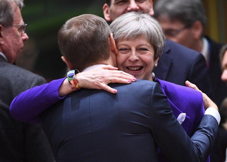 Theresa May greets European Council president Donald Tusk at the EU summit in Brussels