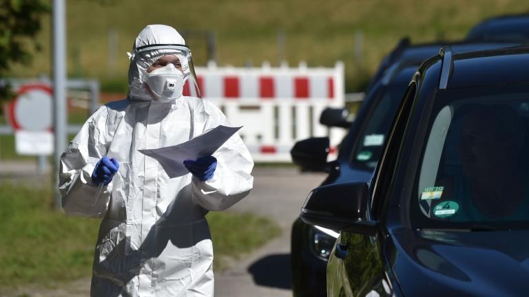 A health worker testing people in cars in Germany