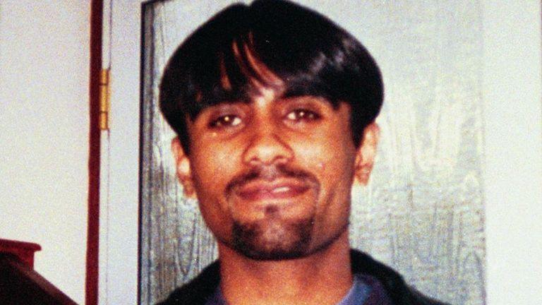 Man with black hair and moustache,  smiling at camera