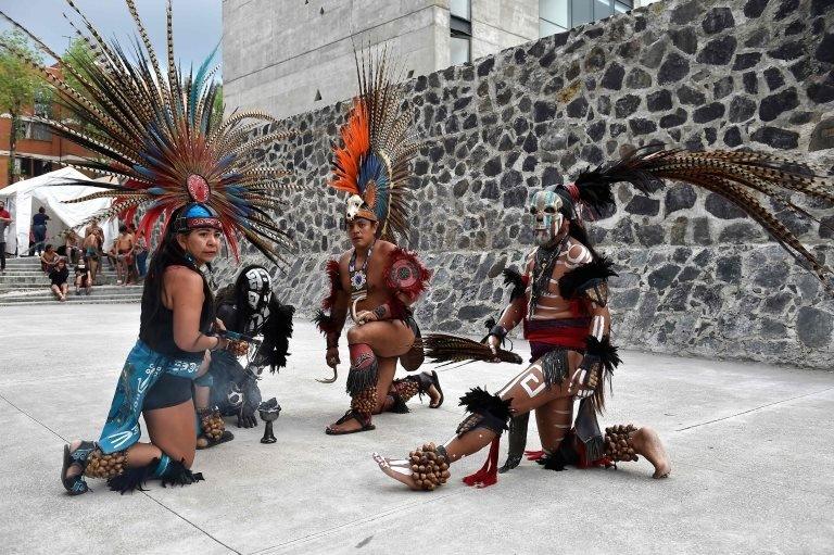 Dancers perform ahead of a pre-Columbian ballgame called "Ulama" -in Nahuatl indigenous language- which rule is to hit a "Ulamaloni" (solid rubber ball) with the hip or shoulder, at the FARO Poniente cultural centre in Mexico City on August 21, 2019