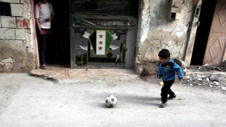 Syrian boy plays at a street in the rebel-held neighbourhood of Tishreen, after a ceasefire came into effect in Damascus, Syria, 27 February 2016