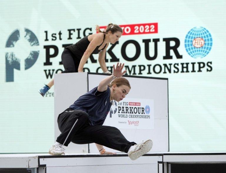 Athletes jumping over an obstacle