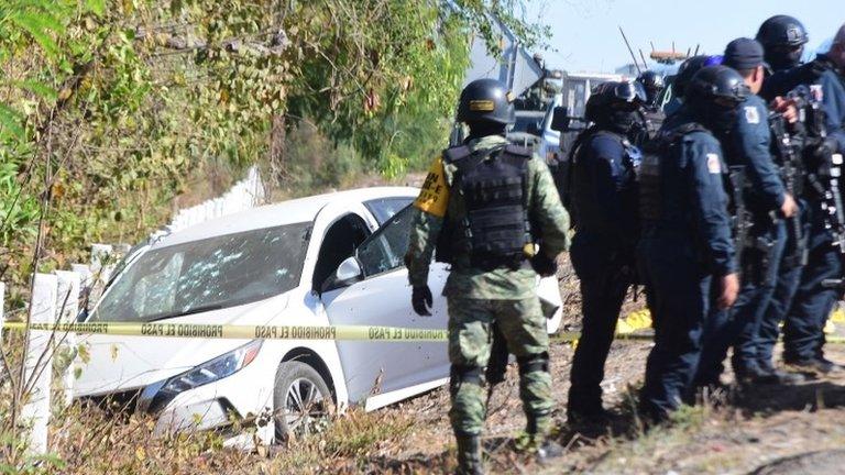 Soldiers of the National Guard and state policemen cordon off the vehicle in which the director of the Sinaloa State Preventive Police, Joel Ernesto Soto, was killed in Culiacan, Sinaloa state, Mexico, 24 May 2021.