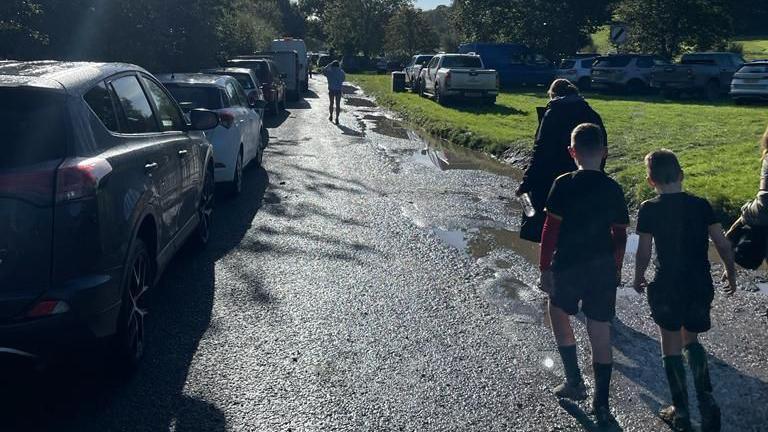 Ceir di parcio, plant yn cerdded i hyfforddiant rygbi/peldroed