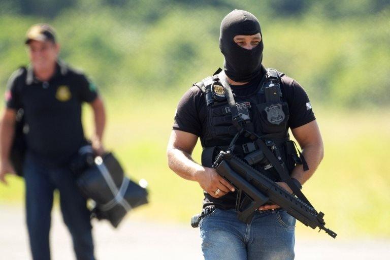 A penitentiary agent guards the arrival of forensic experts at the Altamira Regional Recovery Center, in Altamira, Brazil, 30 July 2019.