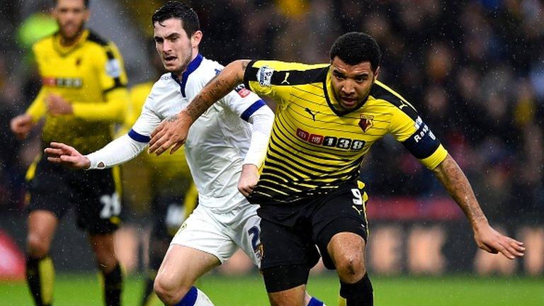 Troy Deeney of Watford and Lewis Cook of Leeds