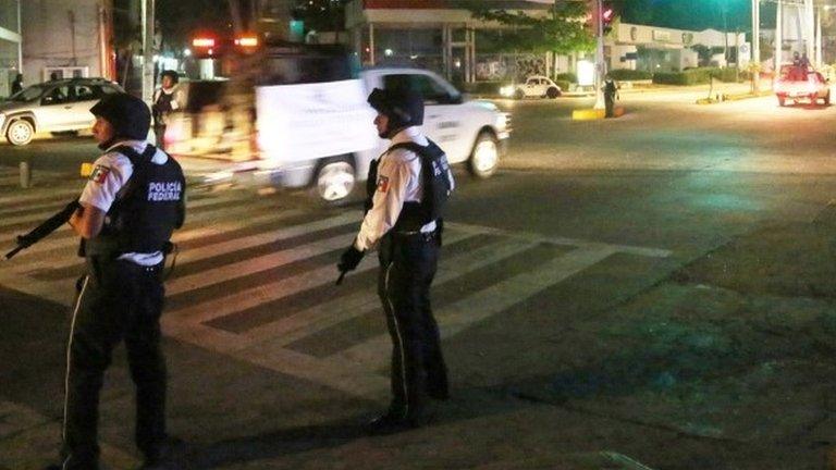 Mexican federal police patrol the streets of Acapulco after 24 April 2016 attack