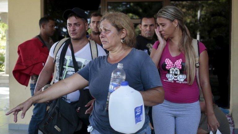 Cuban migrants react after riot police fired tear gas outside the customs building at the border between Nicaragua and Costa Rica on 15 November, 2015