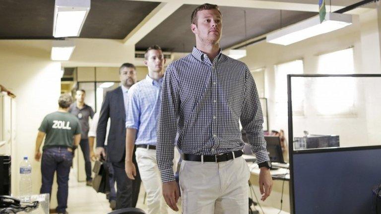 US swimmers Jack Conger and Gunnar Bentz are escorted into a police station the morning after they were stopped from boarding a flight to the United States, in Rio de Janeiro, August 18, 2016.