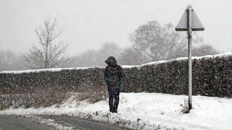 a man walks in the snow