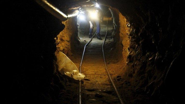 A journalist walks through a tunnel discovered by the Mexican authorities during a presentation to the media in Tijuana on 2 August, 2015.