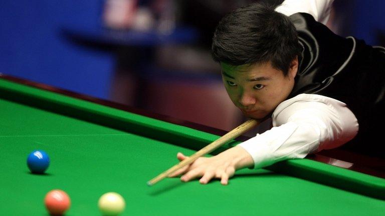 Ding Junhui plays a shot