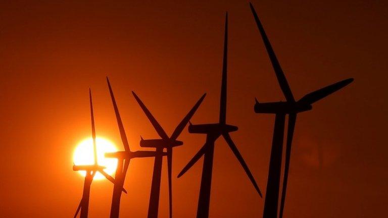 Sun setting over wind turbines