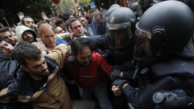 Catalan people who gathered outside the Ramon Llull school clash with Spanish National riot policemen in Barcelona