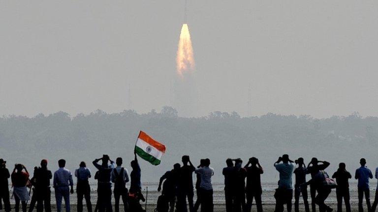 Indian onlookers watch the launch of the Indian Space Research Organisation (ISRO) Polar Satellite Launch Vehicle (PSLV-C37) at Sriharikota on Febuary 15, 2017