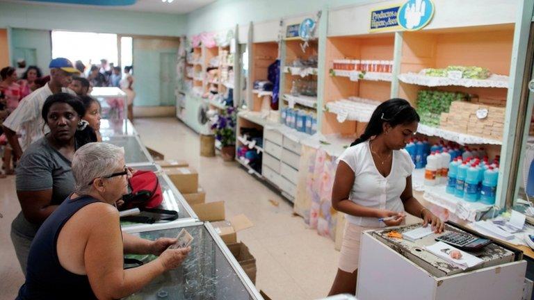 Cubans queue for products in a state shop in Havana