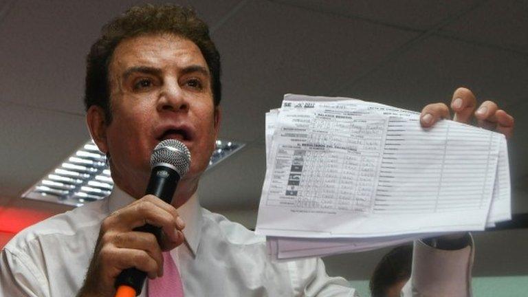 The presidential candidate for Honduras" Opposition Alliance against the Dictatorship, Salvador Nasralla, holds up vote tallies that he claims show that he won the November 26 general elections, in Tegucigalpa on November 29, 2017.