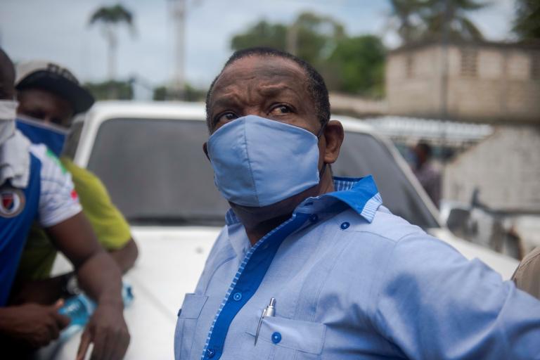 The president of the Haitian Football Federation, Yves Jean Bart (C), looks on outside of the Prosecutor"s Office in Port-au-Prince, Haiti, 14 May 2020