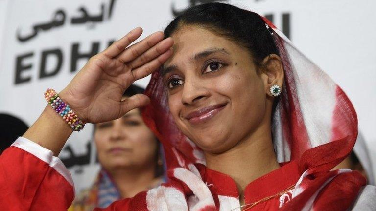 Deaf-mute Indian woman Geeta salutes the media before leaving for the airport from the EDHI Foundation in Karachi on October 26, 2015.