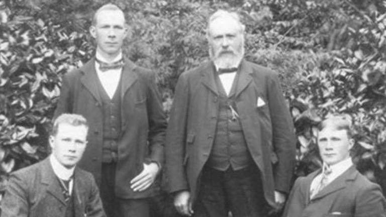 This black and white photograph taken in 1900 and shows Andrew Pettigrew with his three sons, probably in the garden of the family home at Castle Gardens, Cardiff.