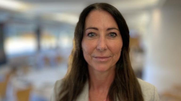 A head and shoulders image of Sheila Oxtoby. She has long brown hair and is wearing a light-coloured suit jacket.