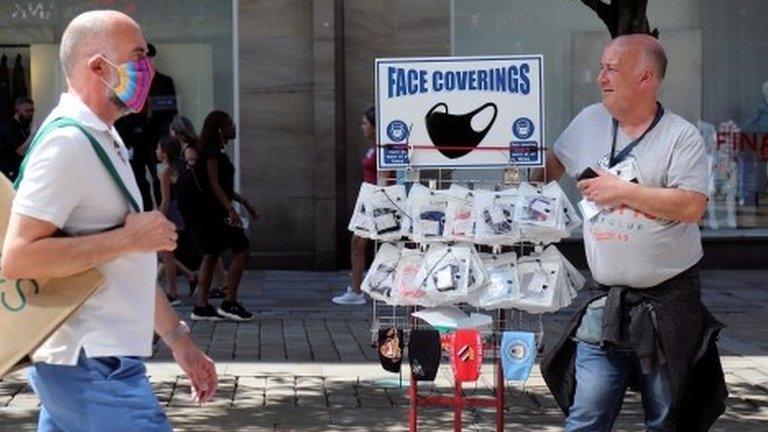 A man sells face masks in Manchester