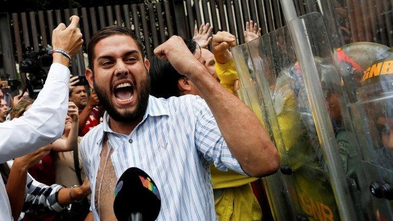 Juan Requesens (C), deputy of the Venezuelan coalition of opposition parties (MUD), clashes with Venezuela"s National Guards during a protest outside the Supreme Court of Justice (TSJ) in Caracas, Venezuela March 30, 2017.