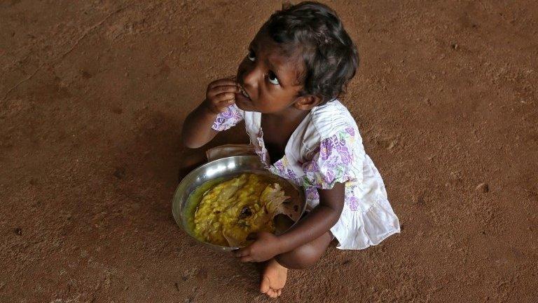 Girl affected by flooding in Kerala, India, 20 August 2018