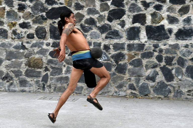 A man plays a pre-Columbian ballgame called "Ulama" -in Nahuatl indigenous language- which rule is to hit a "Ulamaloni" (solid rubber ball) with the hip or shoulder, during a match at the FARO Poniente cultural centre in Mexico City on August 21, 2019