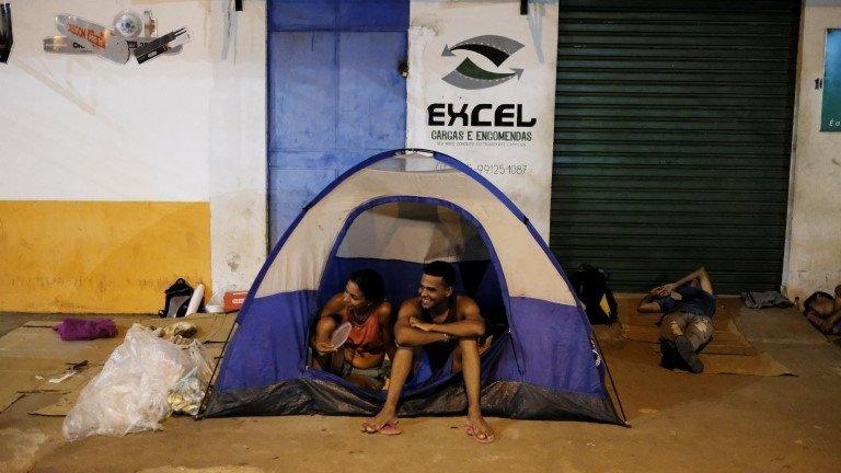 Venezuelan people sit in front of the interstate Bus Station in Boa Vista, Roraima state, Brazil August 25, 2018