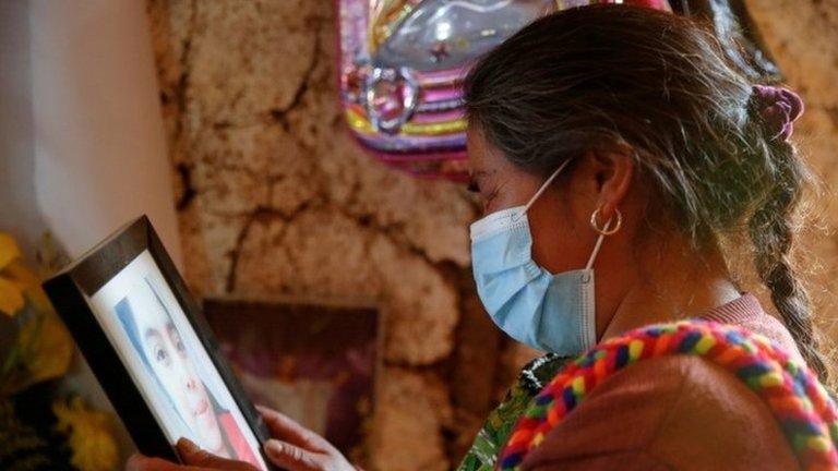 A relative attends the funeral service of Santa Cristina Garcia Perez, one of the migrants killed in the Mexican state of Tamaulipas while trying to reach the U.S., in Comitancillo, Guatemala, March 13, 2021