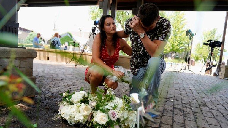 Mourners laying flowers