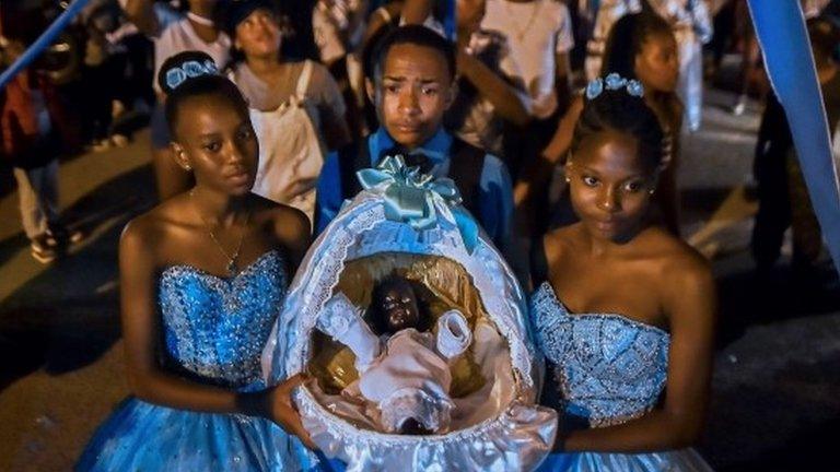 Afro-Colombians hold a basket with "Nino Dios" (God Child) inside in Quinamayo, department of Valle del Cauca, Colombia, on February 18, 2018.