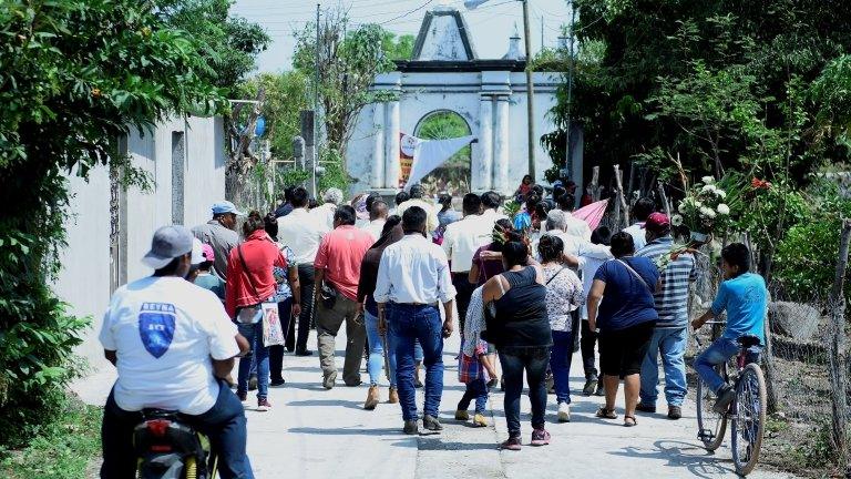 Inhabitants of the Telixtac indigenous community move the remains of a person who died after ingesting allegedly adulterated alcohol, in the municipality of Axochiapan in the state of Morelos, Mexico, 12 May 2020