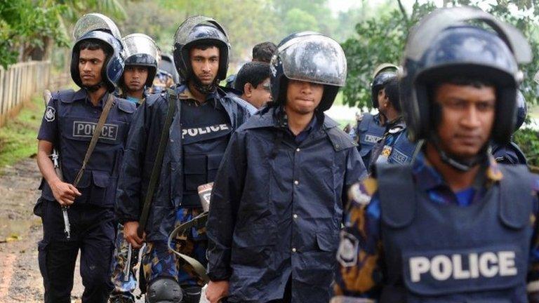 Policemen walk during an operation to storm an Islamist extremist hideout in the town of Moulvibazar on March 30, 2017.