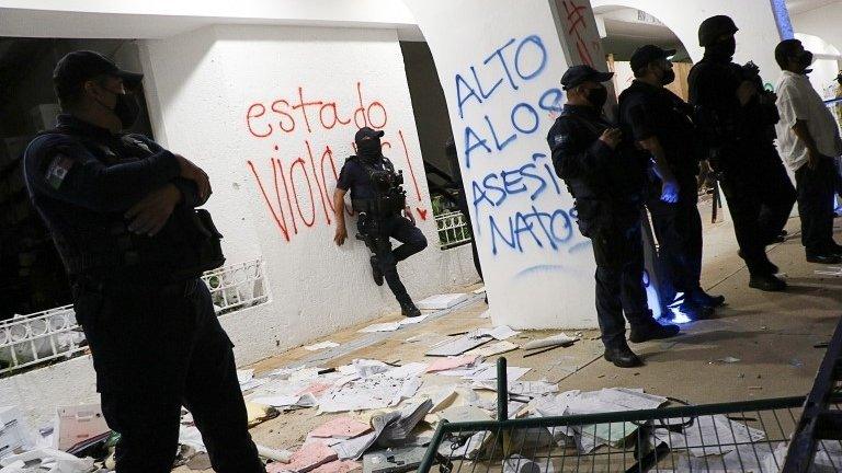 Riot police officers keep watch at the Municipal Palace after a protest to demand justice for the murder of Blanca Alejandrina, known as Alexis, which was disbanded by the police with shots into the air to disperse demonstrators who were vandalizing the government premises, in Cancun, Mexico November 9, 2020