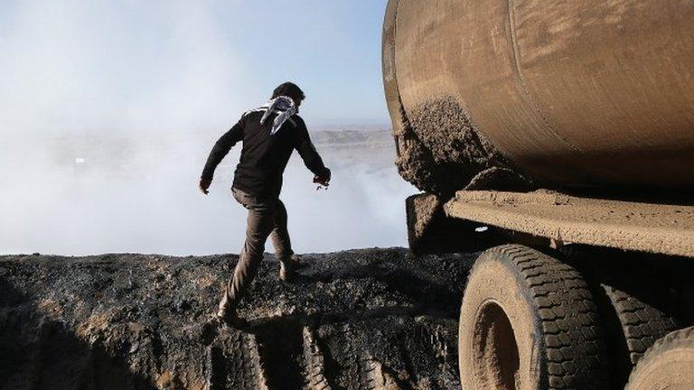 Man walks beside oil tanker near Derek, northern Syria (file photo)