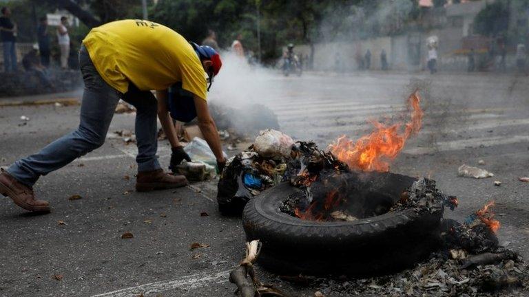 A demonstrator builds a barricade during a protest against Venezuela"s President Nicolas Maduro's government in Caracas, Venezuela May 2, 2017