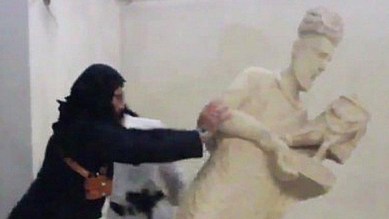 Islamic State militant pushes over statue in Nineveh Museum, Mosul (Feb, 2015)