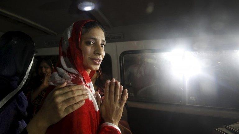 Geeta holds her palms together as she looks out of a van while leaving for an airport to depart for New Delhi, outside the Edhi Foundation in Karachi, Pakistan, October 26, 2015.