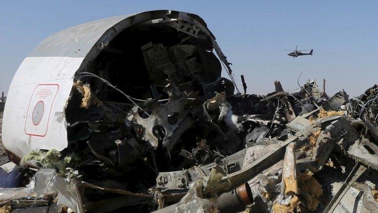 An Egyptian military helicopter flies over debris from a Russian airliner which crashed at the Hassana area in Arish city, north Egypt, in this file photograph dated November 1, 2015