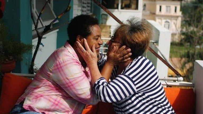 Cuban same-sex couple Mercedes Garcia (R) and Onelia Miranda share a moment at the balcony of their apartment in Havana, Cuba August 10, 2018.