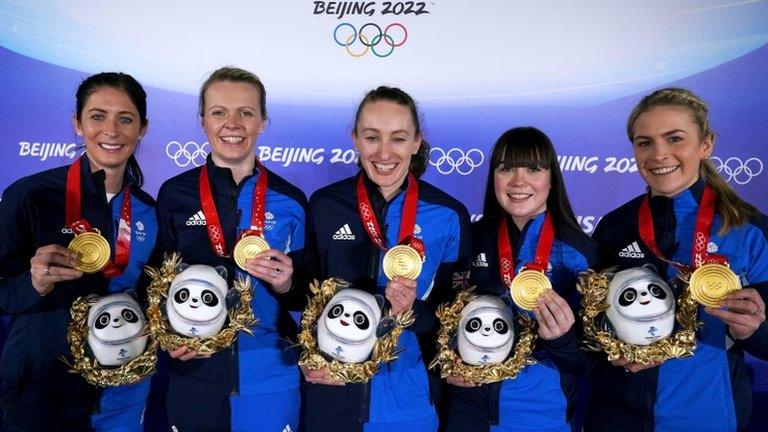 Team GB women's curling team posing with their gold medals