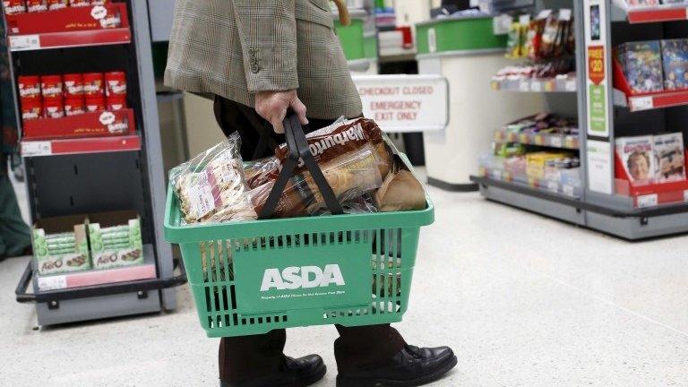 Man carrying Asda basket