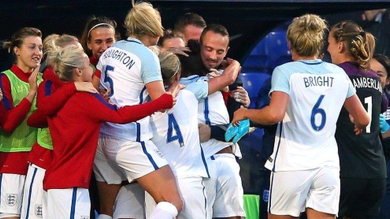 England players embrace Mark Sampson after the opening goal against Russia last month