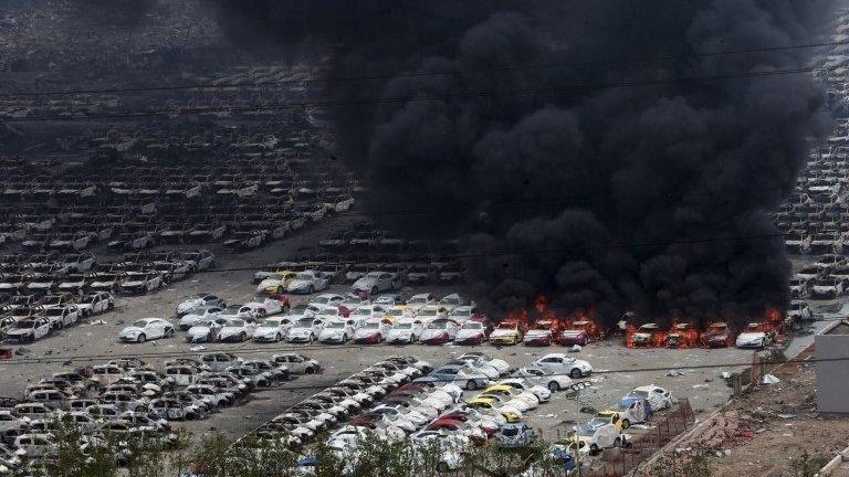 Damaged vehicles burning near blast site - 15 August