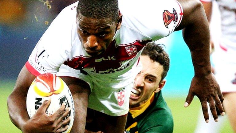 Billy Slater of the Kangaroos tackles Jermaine McGillvary of England