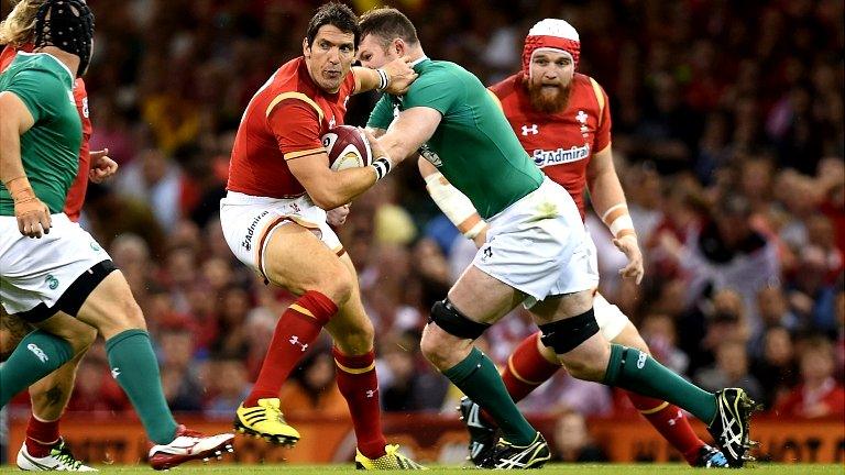 Wales' James Hook (left) is tackled by Ireland's Iain Henderson