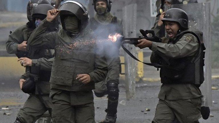 A member of the national guard fires at opposition demonstrators during clashes in Caracas on July 28, 2017.